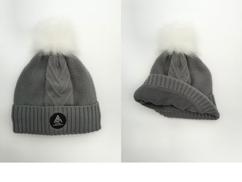 Grå strikkelue med hvit kunstpels-pom pom