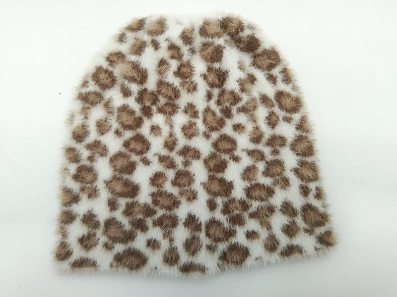 Hvit strikket lue i kunstig pelsmateriale med brune leopardflekker